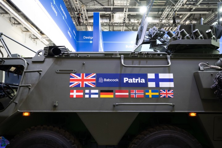 Patria 6x6 vehicle with CAVS programme parteners' flags.