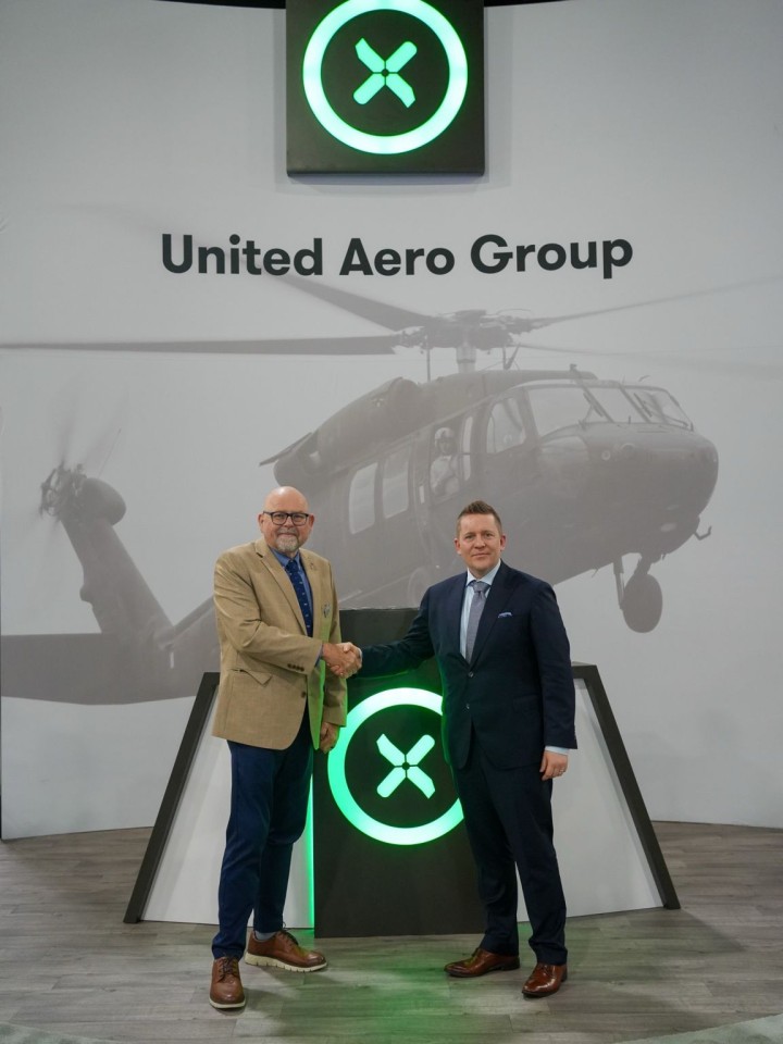 UAG's CEO Thomas Neumann and Patria's Mika Hakanen, VP, Sustainment International shake hands.