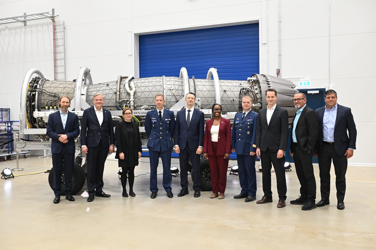 Executives stand in front of the F135 engine.
