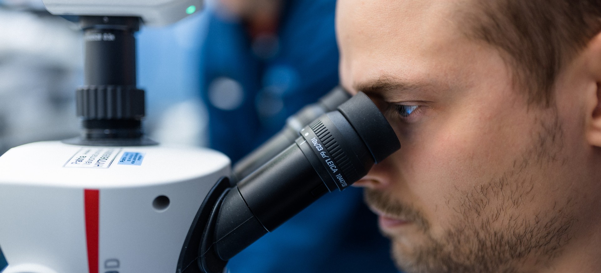 Person working with a microscope.