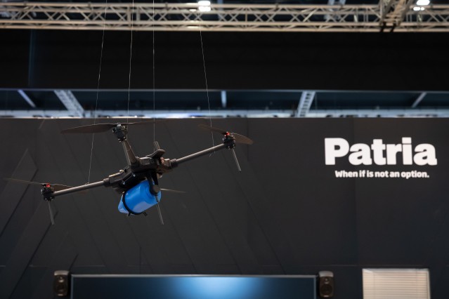 Patria ONE drone hanging in the air at DSEI UK exhibition.