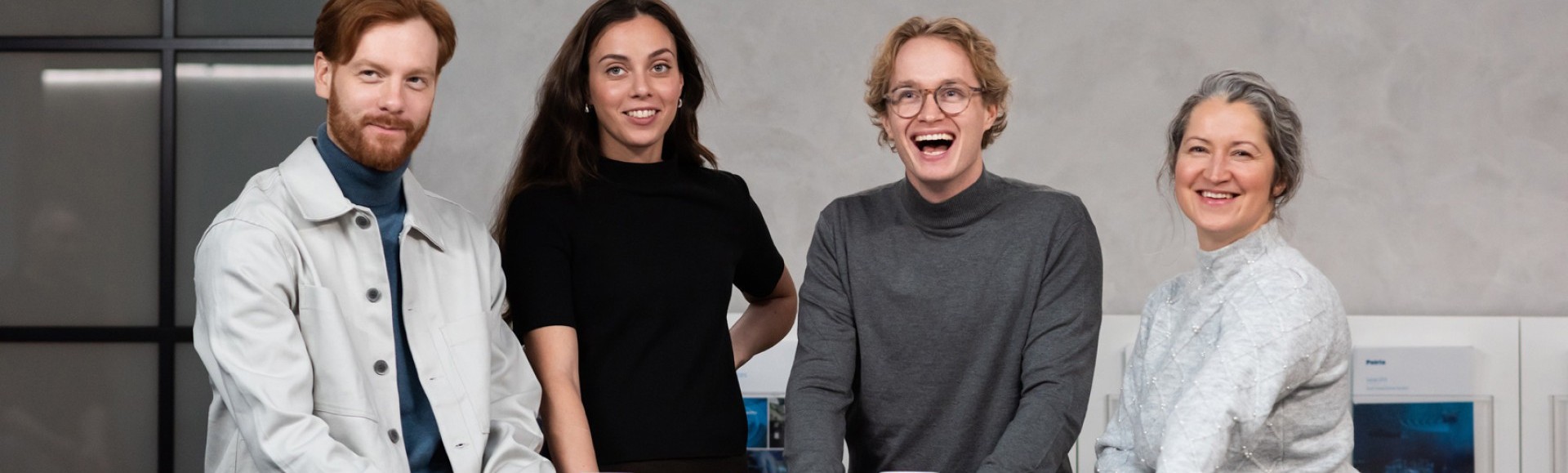 Group of people smiling around a table